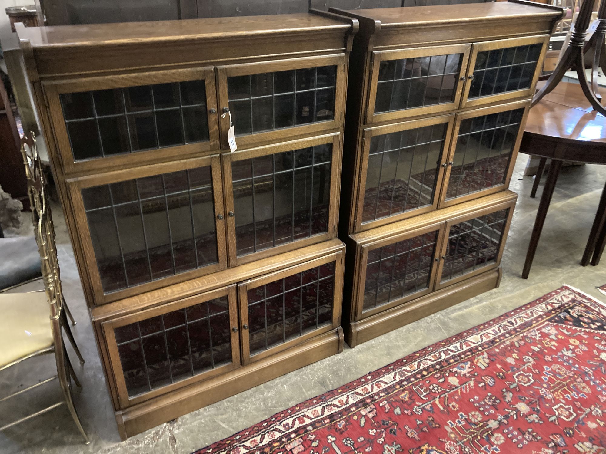 A pair of Globe Wernicke style oak three section leaded glazed bookcases, length 89cm, depth 33cm, height 129cm